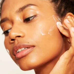 Woman applying hydroquinone cream for skin brightening
