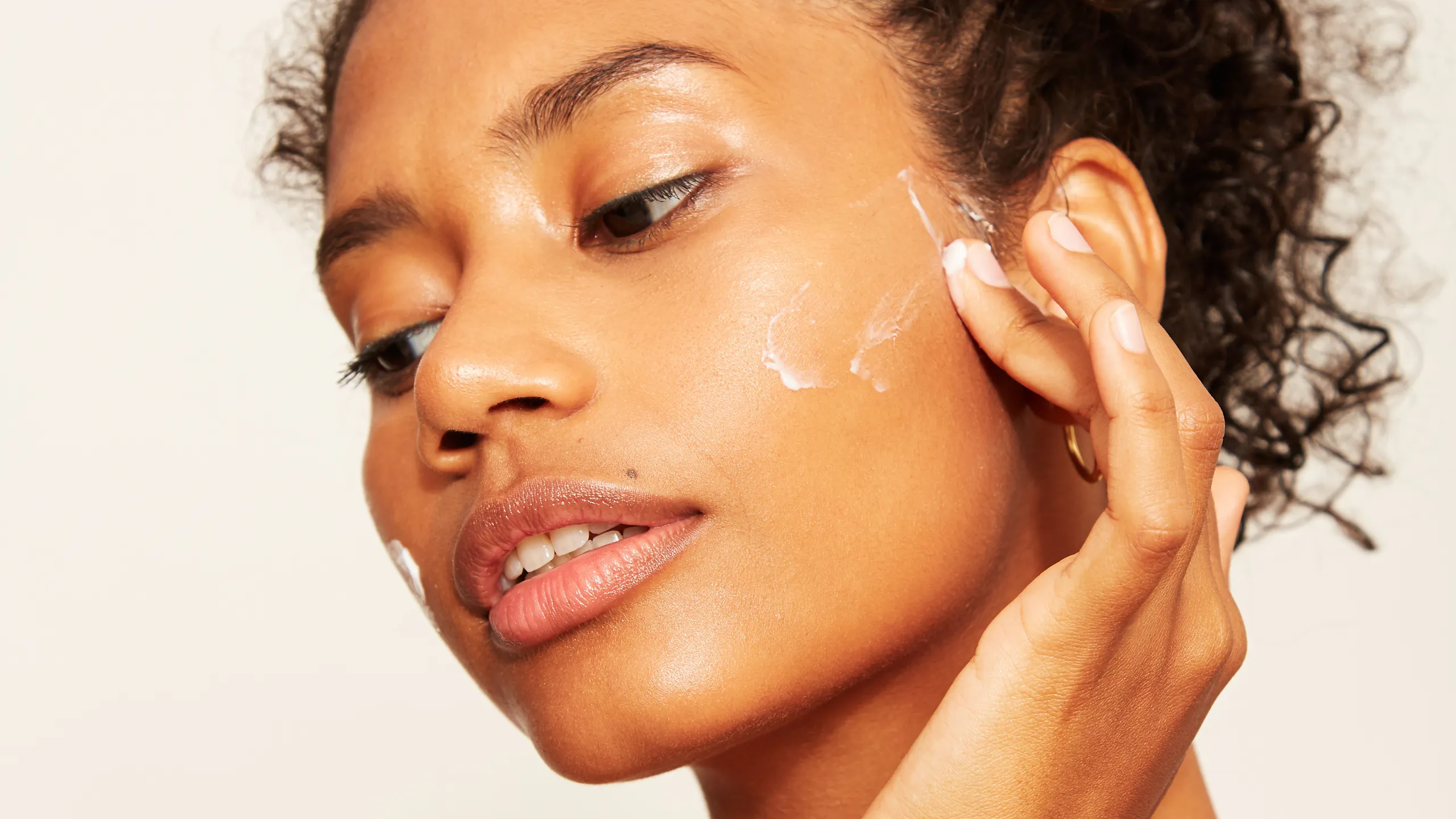 Woman applying hydroquinone cream for skin brightening