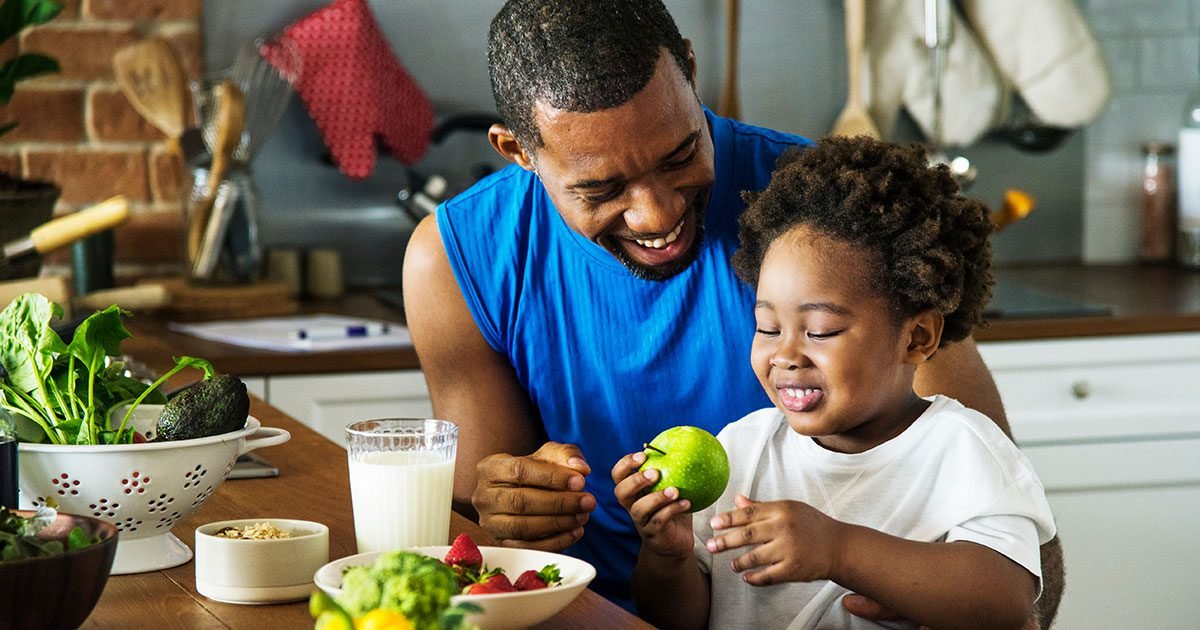 Father and child enjoying healthy food